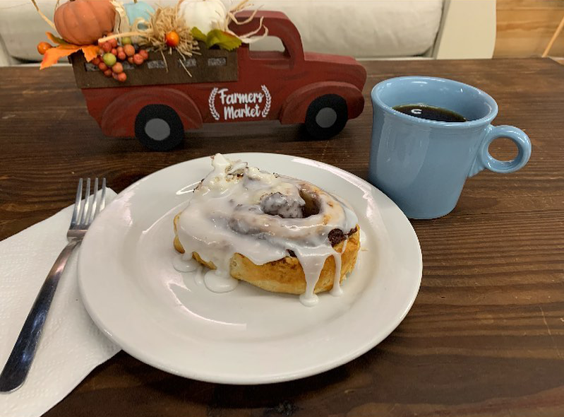 House-baked cinnamon roll with coffee at Caffeine Addicts
